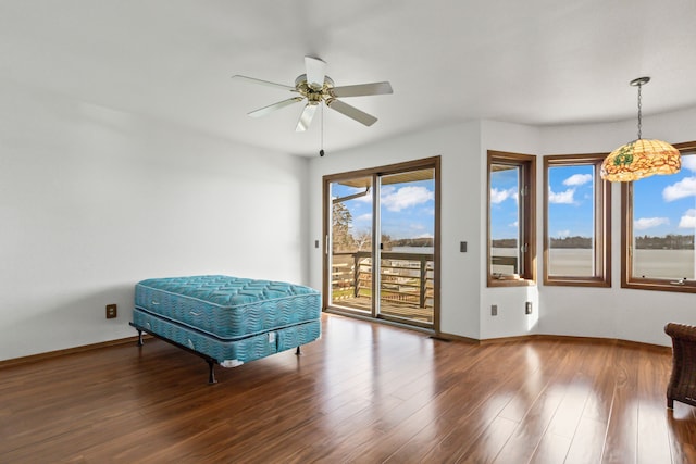 living area featuring wood-type flooring and ceiling fan