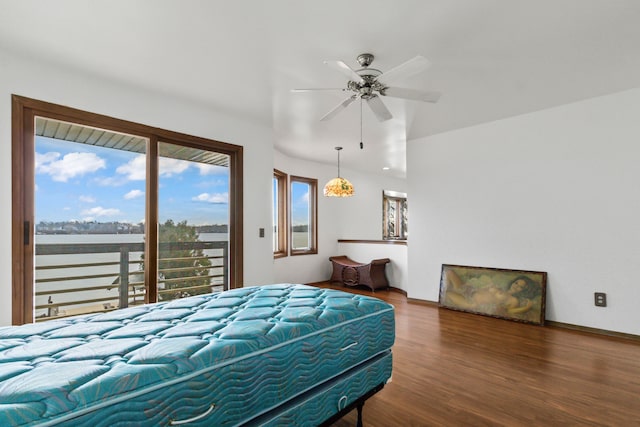 bedroom with access to outside, a water view, hardwood / wood-style flooring, and ceiling fan