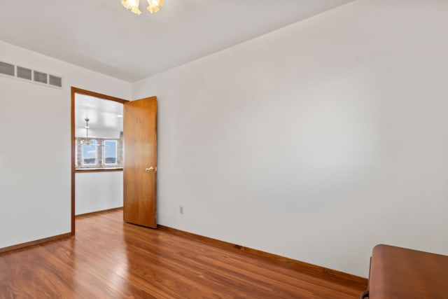 unfurnished room featuring wood-type flooring