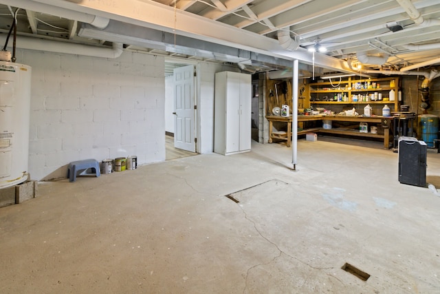 basement with a workshop area and water heater