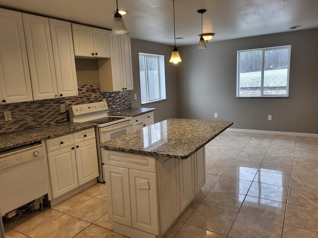 5300 Belford Rd, Holly, MI 48442 - kitchen with white appliances, a kitchen island, tasteful backsplash, dark stone countertops, and decorative light fixtures