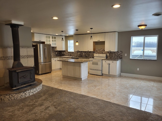 5300 Belford Rd, Holly, MI 48442 - kitchen featuring electric stove, freestanding refrigerator, backsplash, recessed lighting, and glass insert cabinets