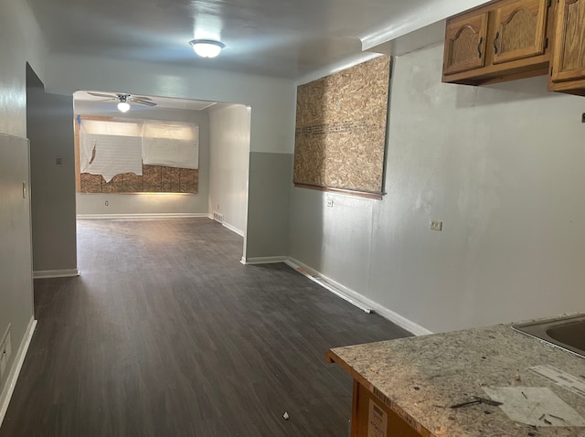 interior space with ceiling fan and dark hardwood / wood-style flooring