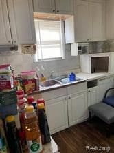 kitchen featuring dark hardwood / wood-style flooring and white cabinetry