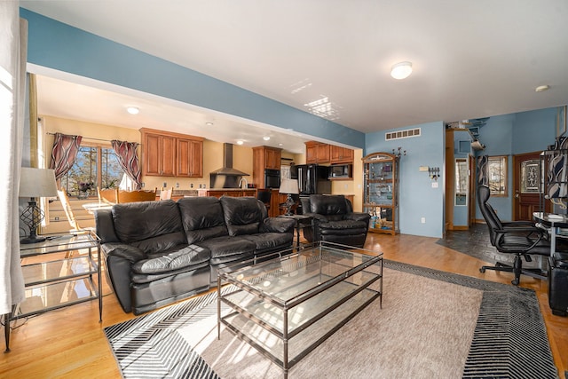 living room with light hardwood / wood-style flooring