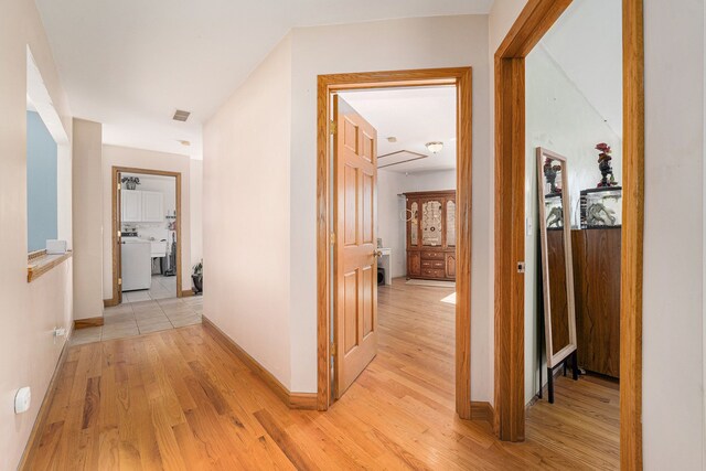 hall with light hardwood / wood-style floors