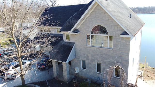 view of property exterior with a water view