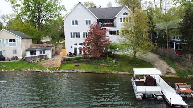 back of property with a water view