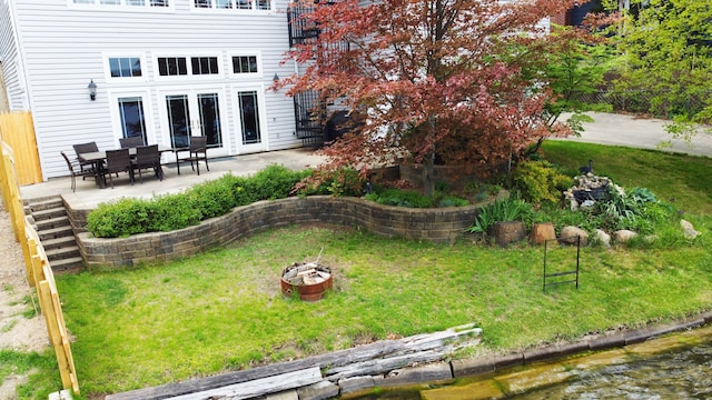 view of yard featuring a fire pit and a patio