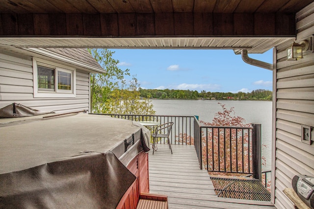 wooden terrace featuring a water view