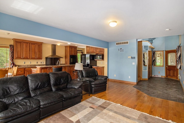 living room with light wood-type flooring and sink