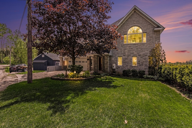 view of front of home with a lawn and a garage