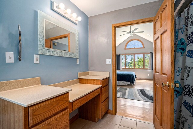 bathroom with hardwood / wood-style flooring, ceiling fan, vanity, and vaulted ceiling