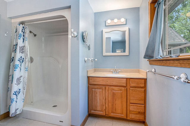 bathroom featuring tile patterned flooring, vanity, and a shower with shower curtain