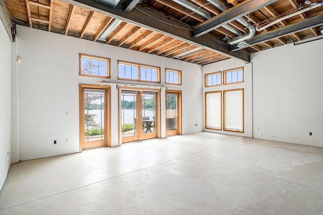 interior space with french doors and a water view