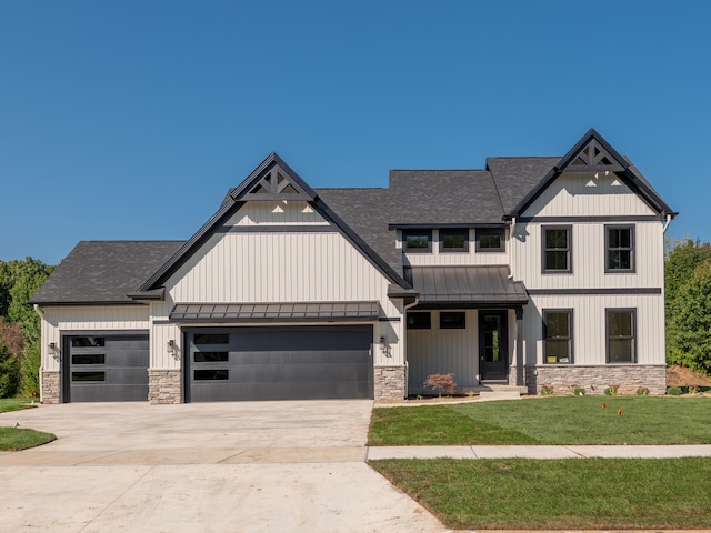 view of front of house with a front yard and a garage