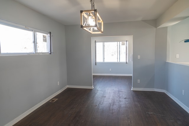 unfurnished dining area featuring dark hardwood / wood-style floors