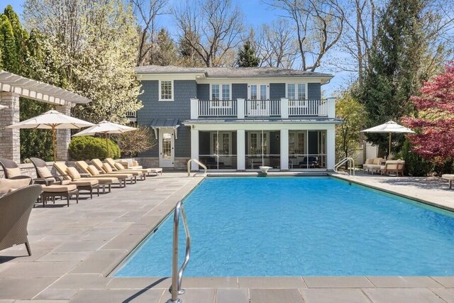 49106 Sun Valley Falls Blvd, New Buffalo, MI 49117 - back of property with a balcony, a patio area, outdoor lounge area, and an outdoor pool