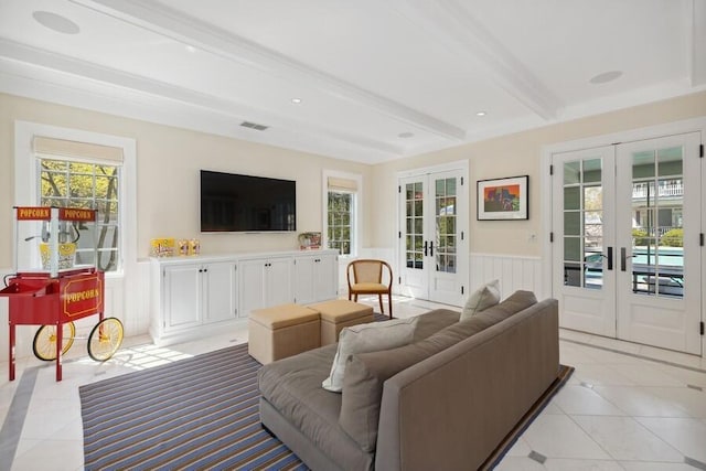 49106 Sun Valley Falls Blvd, New Buffalo, MI 49117 - living area featuring french doors, beam ceiling, light tile patterned floors, and a wainscoted wall