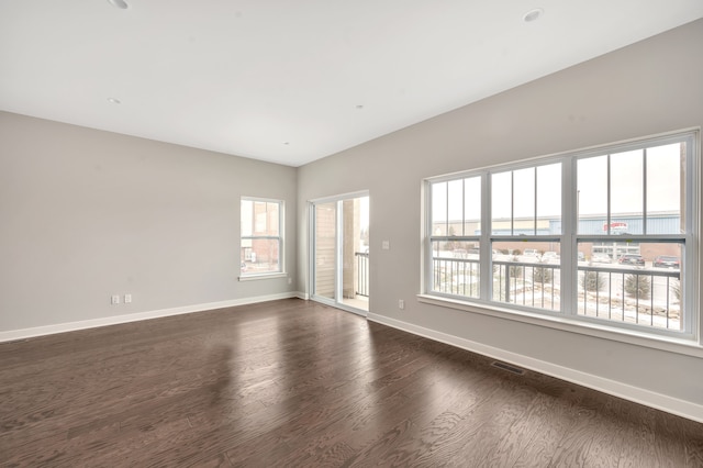 spare room featuring dark wood-type flooring