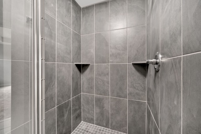 bathroom with tiled shower