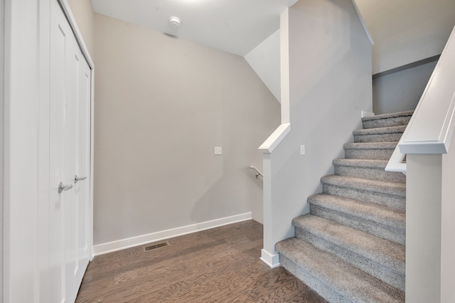 stairs featuring hardwood / wood-style floors