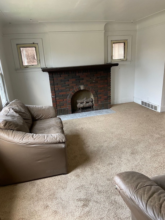 carpeted living room featuring a brick fireplace