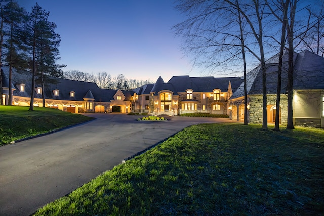 french country home with a lawn