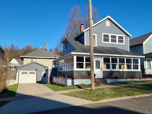 view of front of house featuring a garage and an outdoor structure