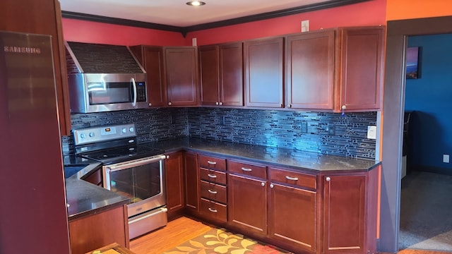 kitchen featuring backsplash, crown molding, light wood-type flooring, and appliances with stainless steel finishes