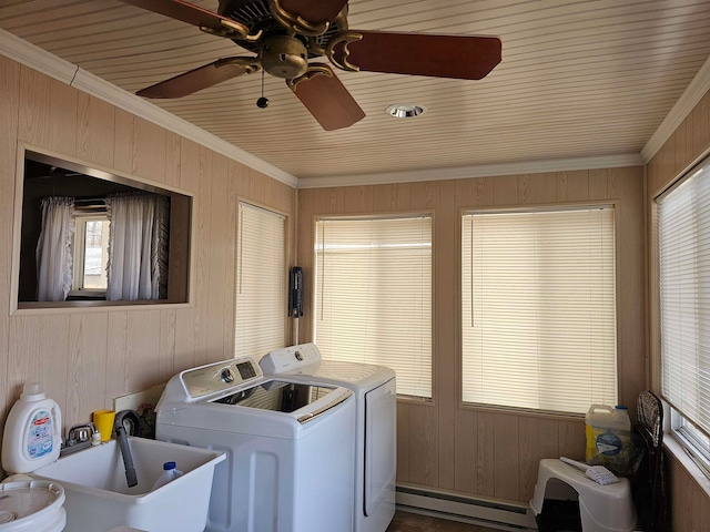 washroom with washer and clothes dryer, wood walls, sink, ornamental molding, and baseboard heating