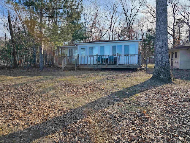 rear view of house with a wooden deck