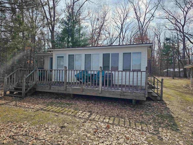 back of property with a wooden deck