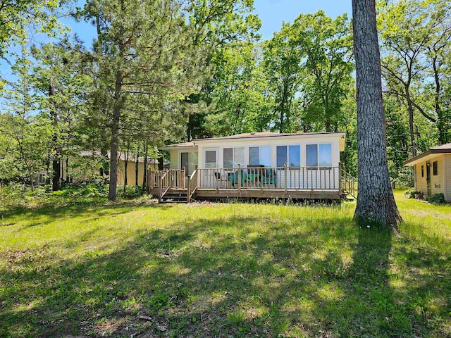 back of house with a wooden deck and a yard