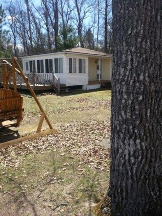 rear view of property featuring a deck