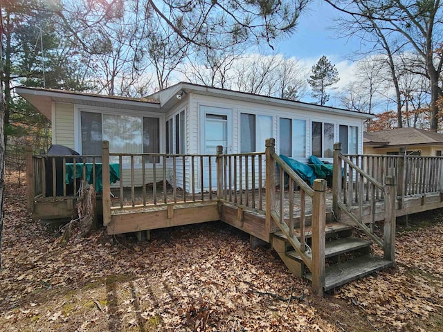 back of property with a wooden deck