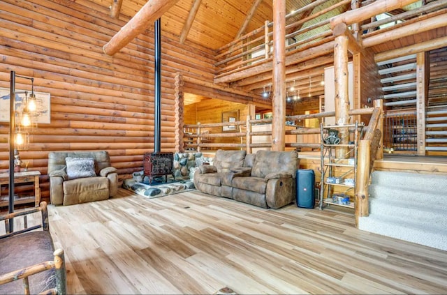 unfurnished living room featuring wood-type flooring, beam ceiling, high vaulted ceiling, wooden ceiling, and a wood stove