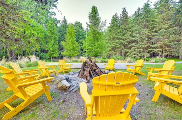 surrounding community featuring an outdoor fire pit