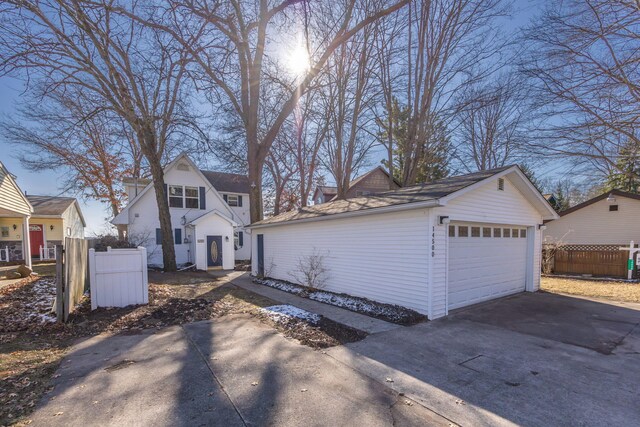 view of side of home with an outdoor structure and a garage