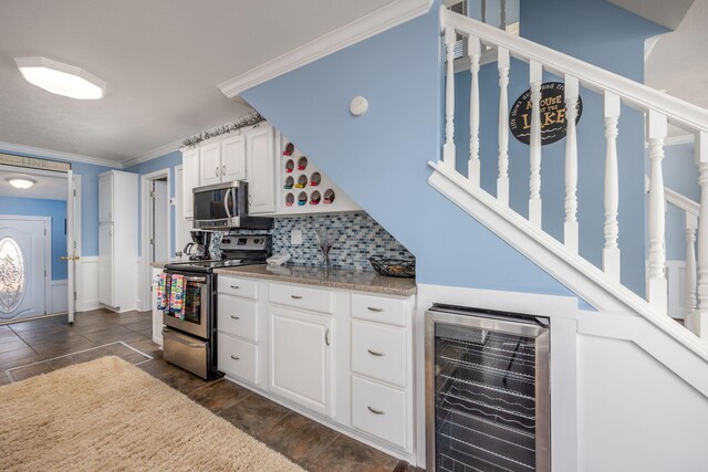 kitchen with white cabinetry, stainless steel appliances, tasteful backsplash, wine cooler, and crown molding