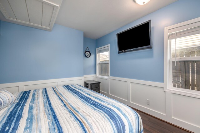 unfurnished bedroom featuring dark hardwood / wood-style flooring and multiple windows