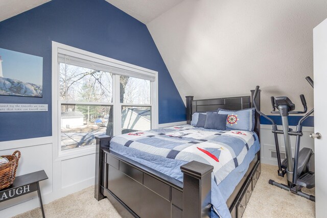 bedroom with light carpet and vaulted ceiling