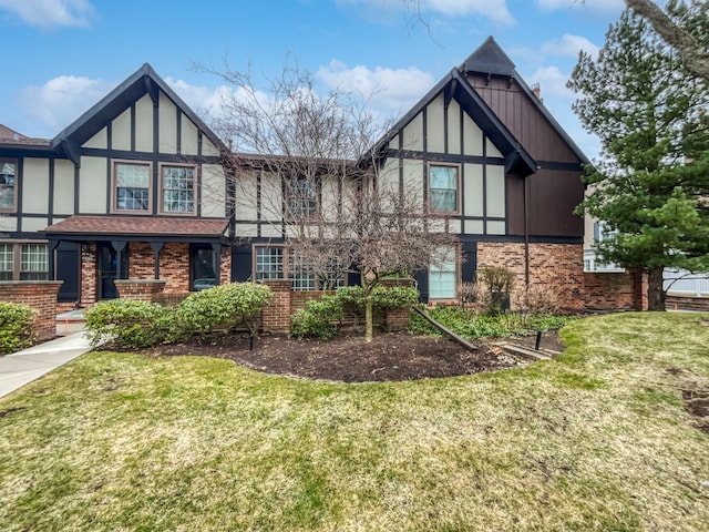 tudor house featuring a front yard