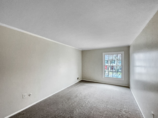 carpeted spare room with a textured ceiling