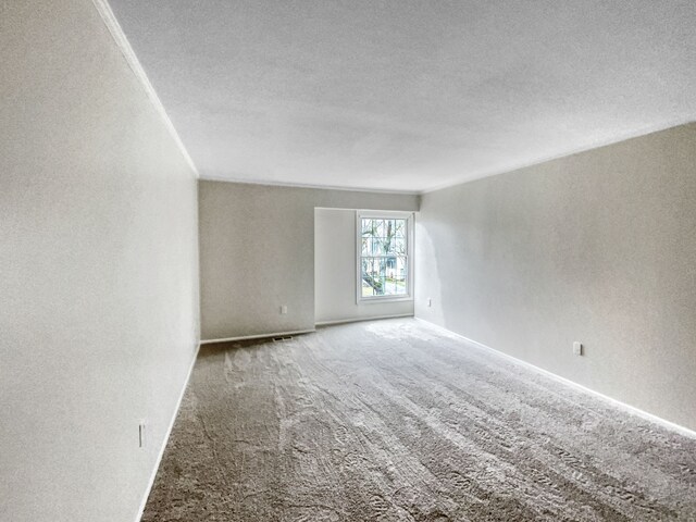 22037 Shore Pointe Ln # 64, Saint Clair Shores, MI 48080 - carpeted empty room featuring a textured ceiling, baseboards, and a textured wall