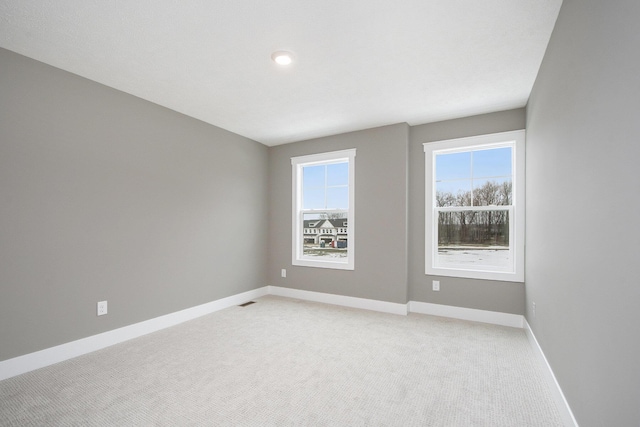 empty room featuring light colored carpet