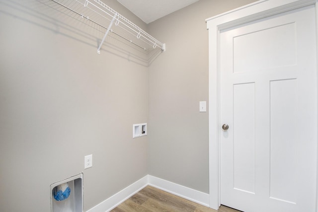 washroom with hookup for a washing machine and hardwood / wood-style flooring