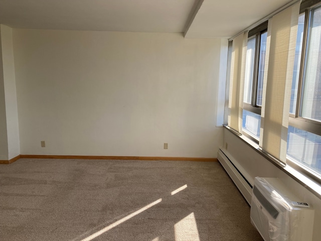 empty room featuring carpet floors, a wall mounted AC, and a baseboard radiator