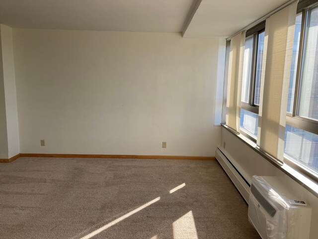 8900 E Jefferson Ave Unit 1431, Detroit, MI 48214 - carpeted empty room with a baseboard radiator, baseboards, and an AC wall unit