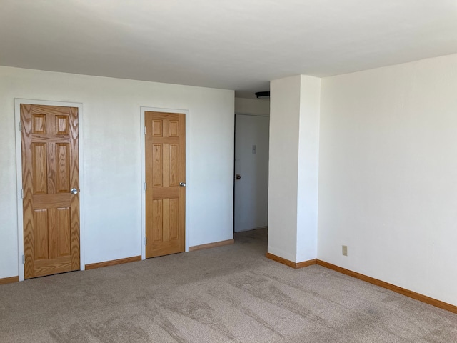 unfurnished bedroom featuring light colored carpet